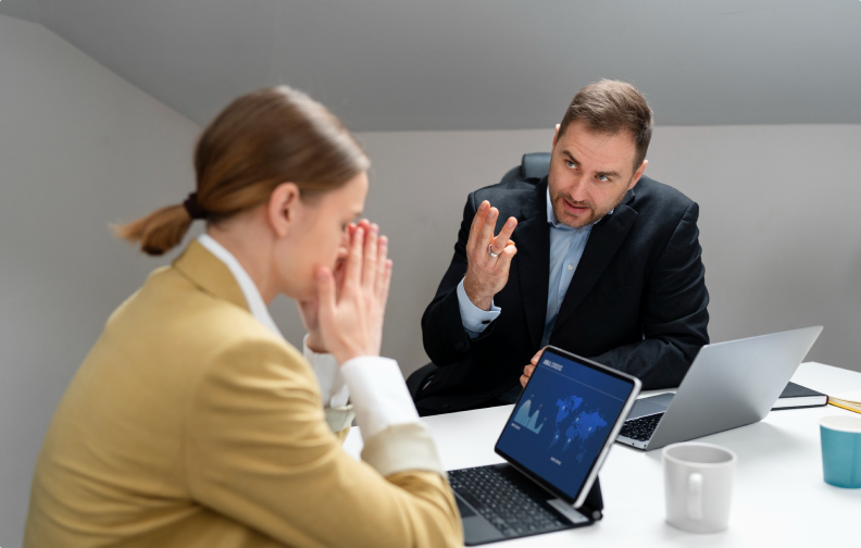 Two professionals are having a serious discussion in an office about risk management services in Florida.