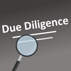 Image featuring the words "Due Diligence" underlined by two white lines, with a magnifying glass pointing upwards