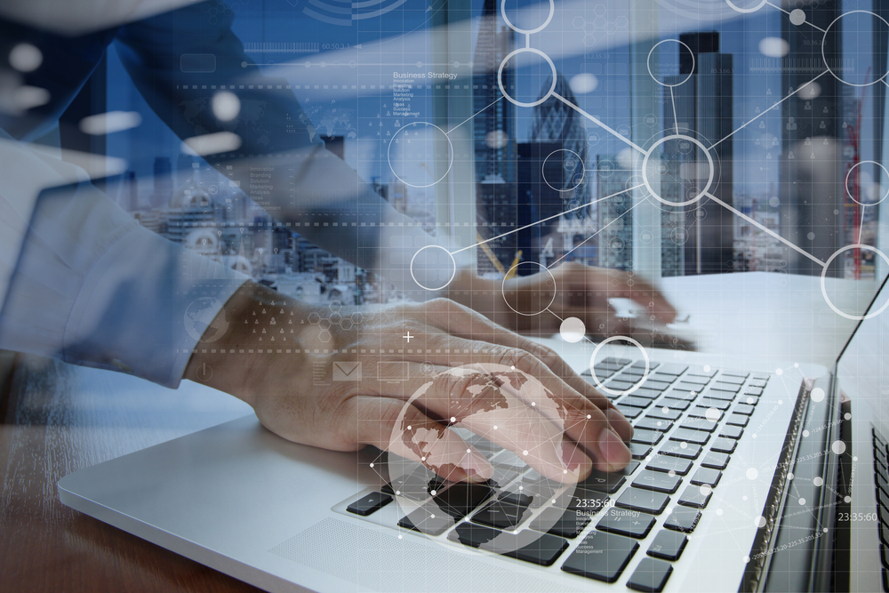 Person typing on a laptop, overlaid with connected digital icons and an image of a cityscape in the background.