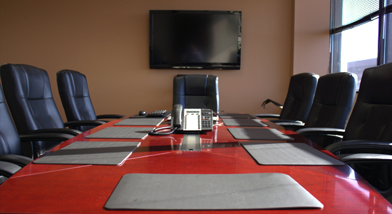 A modern conference room with A large screen perfect for presentations on risk management services in Florida.