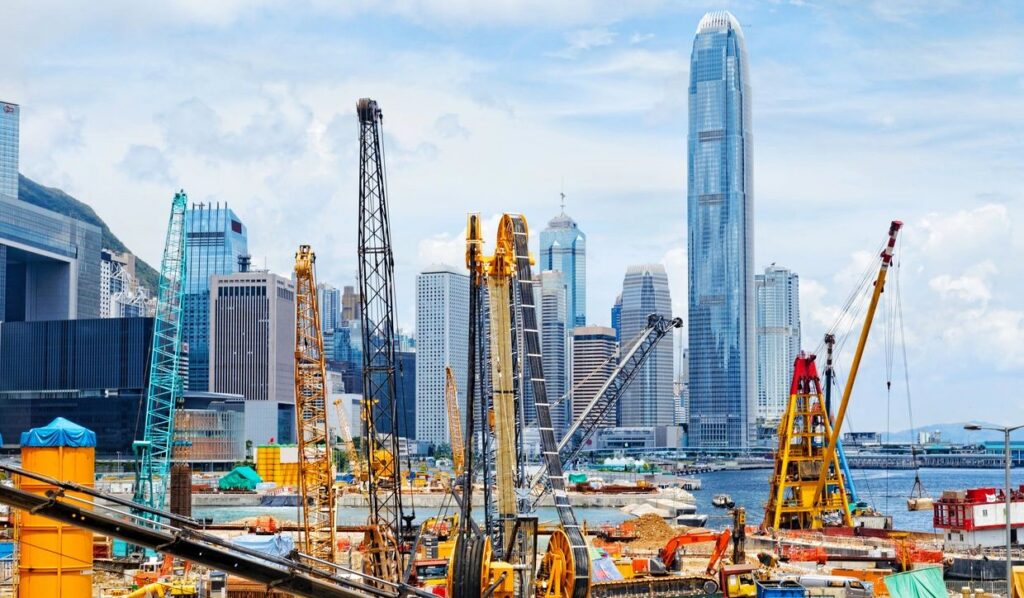 Construction site with city skyline backdrop